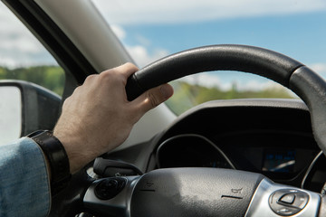 hand on the steering wheel of the car. traffic, driving. bangs holding the steering wheel