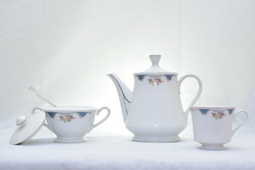 Mock up / design set of elegant and traditional teapot colorful white and blue coffee cup & Tea cup on cup's plate beside the hot tea pot , design/ drink-ware isolated on white background