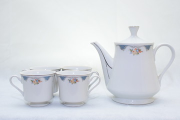 Mock up / design set of elegant and traditional teapot colorful white and blue coffee cup & Tea cup on cup's plate beside the hot tea pot , design/ drink-ware isolated on white background