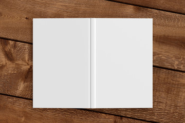 Blank white vertical open and upside down book cover on wooden boards isolated with clipping path around cover. 3d illustration