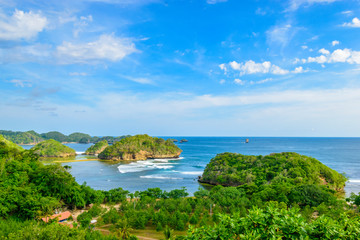 Beautiful group of islands amid blue sea water in a sunny afternoon at Asmara Bay, East Java, Indonesia