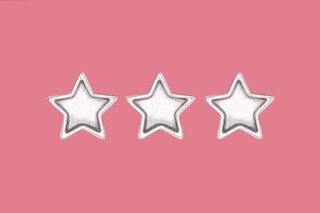 Fototapeta na wymiar Three five pointed golden stars on pink background.