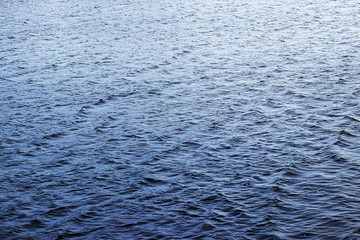 Texture of dark water in river with illumination above_