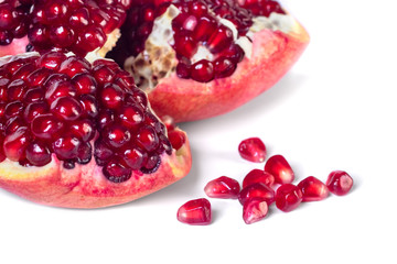 Ripe pomegranate fruit with seeds isolated on white