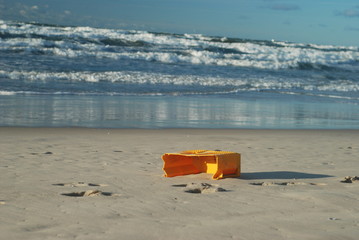 Old fisherman's box on the beach of the stormy sea