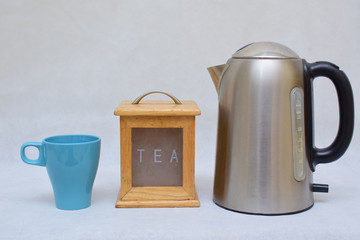 Mockup / design set of colorful Tea or coffee ceramic mug beside wooden tea kitchen box and stainless steel kettle .  template for branding identity and company logo design/ drink-ware, Dining 