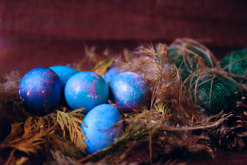 space galactic Easter eggs in nest next to cone and green filler