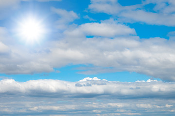Beautiful blue sky with white clouds and sun