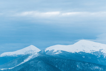 Fototapeta na wymiar scenic view of snowy mountains and cloudy sky