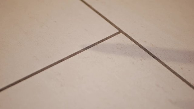 Blood dropping on floor with weapon knife shadow, closeup