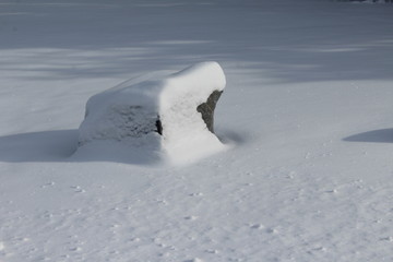 snow covered rock in winter