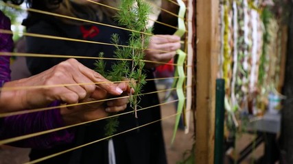 Close up footage of people collaborating on a large WamPum during a festival celebrating Native American tradition and culture, with copy space