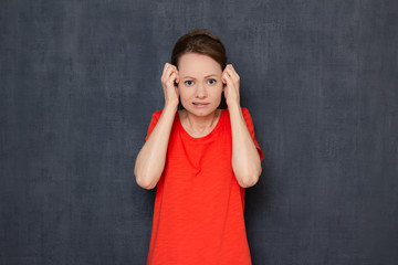 Portrait of upset disappointed worried girl raising hands to head