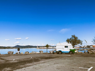 Small vintage van on the parking by the sea