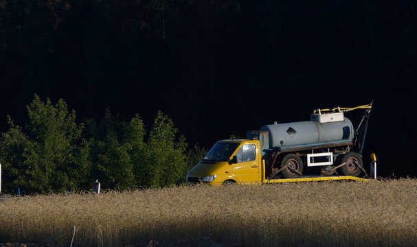 Tow Truck And Old Slurry Tanker Trailer