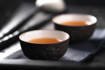 Asian tea ceremony. Chinese ceramic tea cups on stone dark background