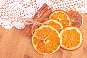 Cinnamon sticks, slices of dried orange, on wooden background. View from above. Christmas and New Year celebration concept. winter and autumn.