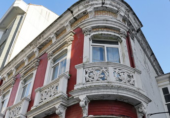 Facade of a modernist style building. Stresses its beautiful cornice, nuanced with a continuous line of beautiful hydraulic tile