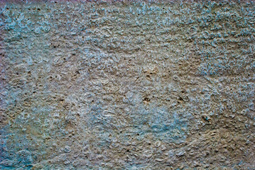 concrete wall interspersed with gravel in rich colors.