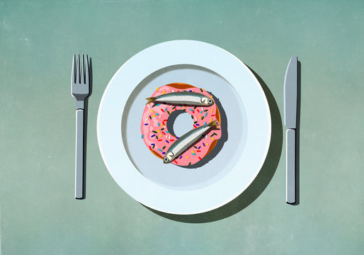 Sardines on top of donut on plate