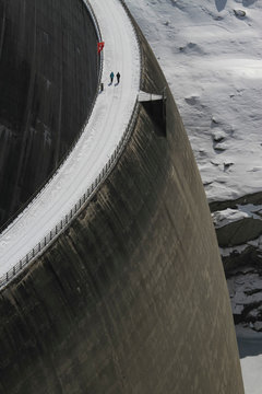 People walking across snow covered dam, Vals, Canton of Grisons, Switzerland