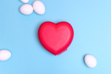 fresh white farm easter egg with colored kitchen equipment on pink/blue background. cooking/ easter concept flat lay with copy space