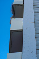 High-rise building with external staircase in the style of the eighties