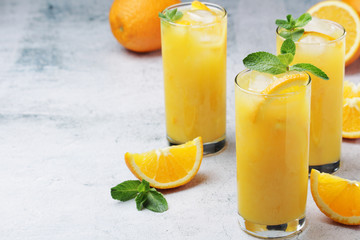 Glasses full of orange juice with ice