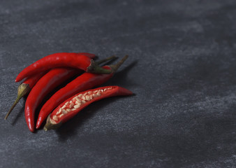 Red hot chili pepper on a black background. Place for text.