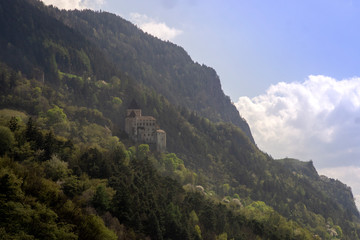 Fototapeta na wymiar fortress on a steep mountainside. forest mountains