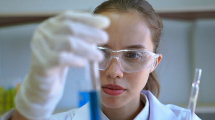 Female scientist shows test tube with pride in their work