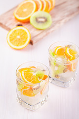 Summer refreshing non alcoholic cocktails with orange and kiwi fruits closeup still life. Summer mocktail with citrus and sparkling water, healthy lifestyle concept
