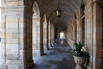 'Pazo de Raxoi' arcades, building of the town hall of Santiago de Compostela Santiago de Compostela, Galicia, Spain.Sunrise, beautiful shadow