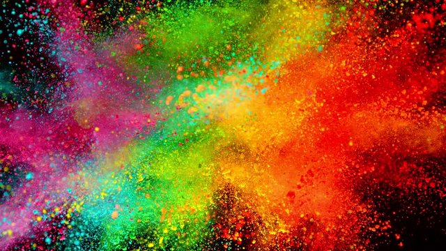 Colorful powder exploding on black background in super slow motion, close-up.