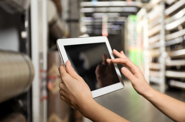 Woman with tablet in wholesale warehouse, closeup. Space for design