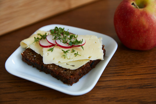 Open sandwich with cheese, radish and cress