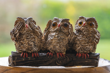 Close up of three ornamental owls depicting the proverb.See no evil.Hear no evil.Speak no evil.