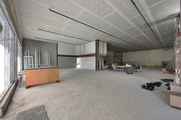 Under construction empty commercial retail space for rent with white walls 