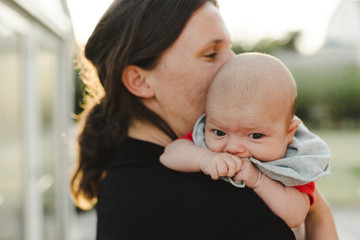 Mother carrying baby daughter