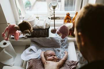Baby lying on changing table