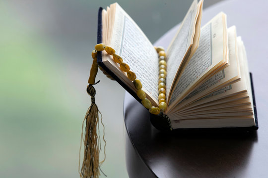 An open Holy Quran and Muslim prayer beads, Ho Chi Minh City, Vietnam
