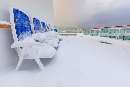 Cruise ship on an Arctic Winter voyage, fresh powder snow on decks, off Troms County, North Norway