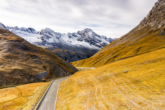 View by drone of scenic road in the autumnal landscape towards Cresta Di Reit, Braulio Valley, Bormio, Valtellina, Lombardy