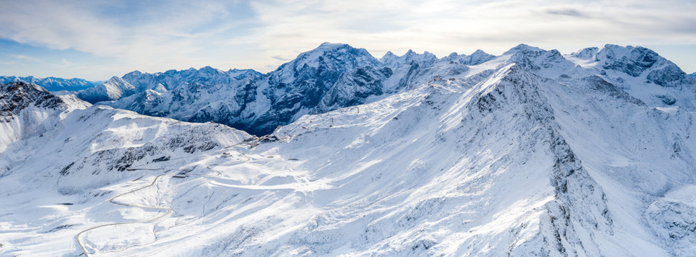 Aerial view by drone of Stelvio Pass road and snowy Ortles mountain, Sondrio province, Valtellina, Lombardy