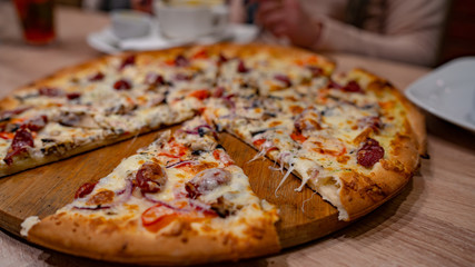 Pizza. Delicious hot pizza on the table in the cafe