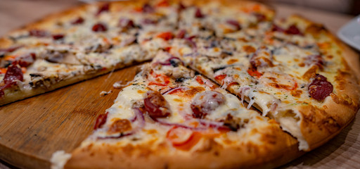 Pizza. Delicious hot pizza on the table in the cafe