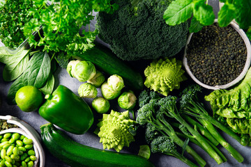 Variety of Green Vegetables and Fruits on the grey background