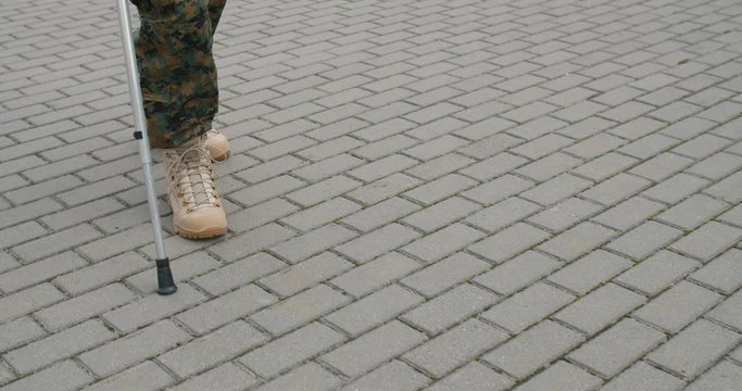 Crop view of soldiers legs and crutch.