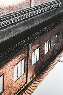 Brick building reflecting in water