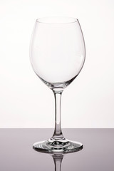 One clean clear wineglass glass on white